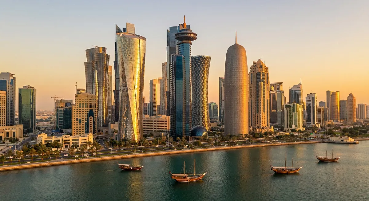 Doha West Bay skyline at sunset showing modern business towers and waterfront in Qatar.