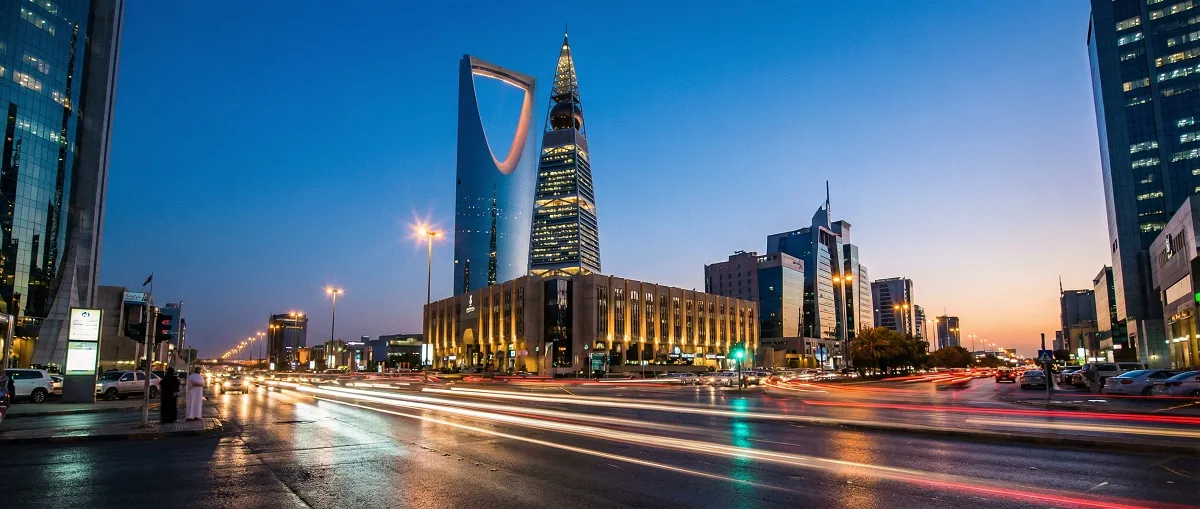 King Fahd Road in Riyadh at blue hour with illuminated skyscrapers and car light trails