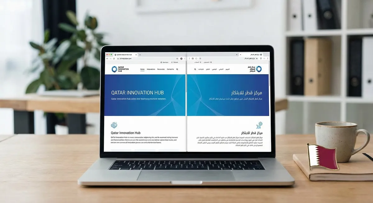 Bilingual website design in English and Arabic displayed on a laptop in a Qatar office setting