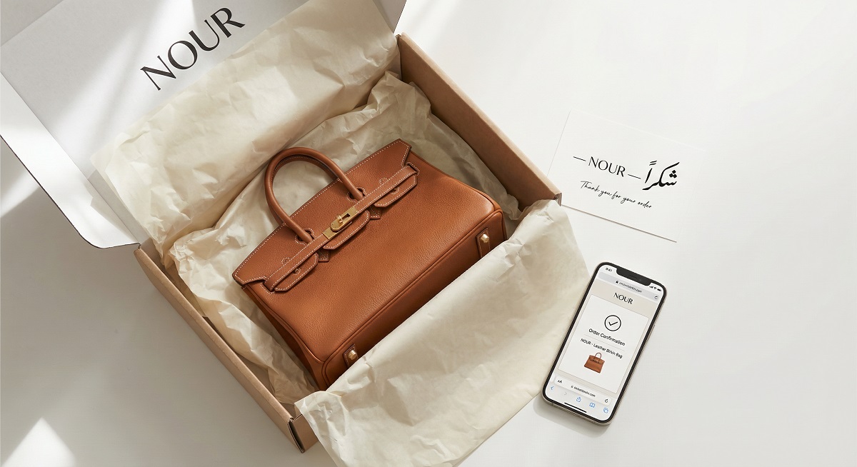 Luxury product unboxing experience with Arabic thank you card and phone showing order confirmation in UAE.